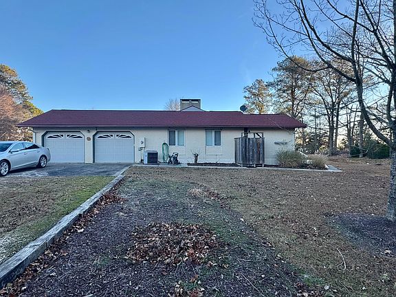 EXTERIOR SIDE HAS 2 CAR GARAGE AND EXT STALL SHOWER