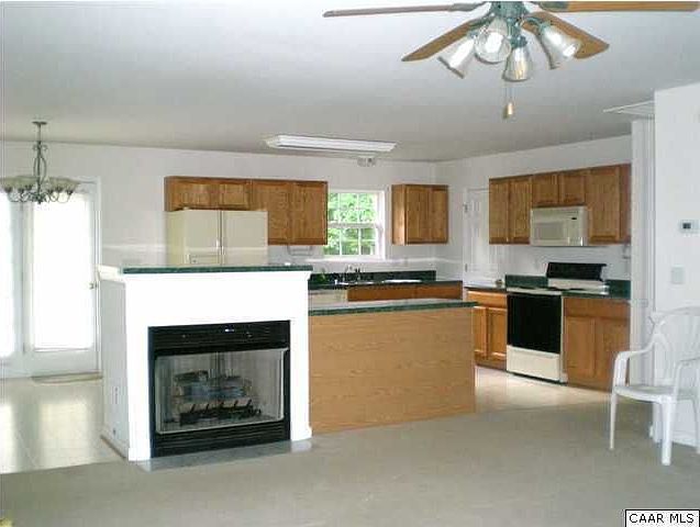 Living room with open floor plan to lg. kitchen & dining area, gas fireplace