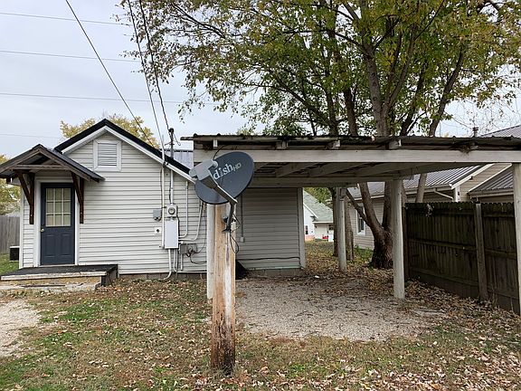 Back of home with carport