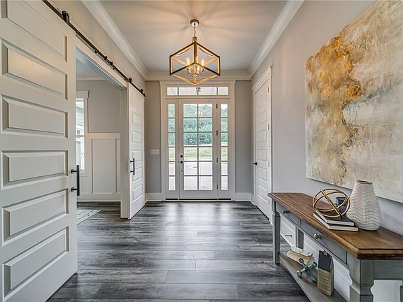 Image 4: Gorgeous Entry is Flanked By Separate Dining Room with Barn Doors