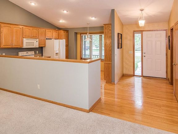 Open entry has oak hardwood flooring and convenient coat closet.