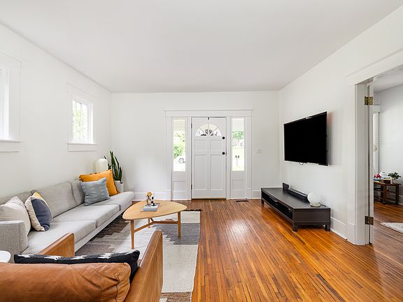 Natural light and original windows and flooring in this freshly updated living room