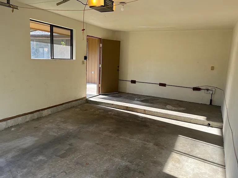 Extra long garage with extra storage space and deadbolt side door. Electric panel in garage.