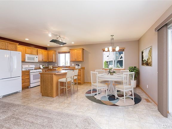 Open layout with dining, breakfast bar, access to the patio.