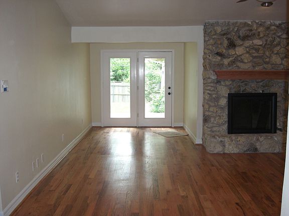 Den, fireplace, sunroom, wood floors