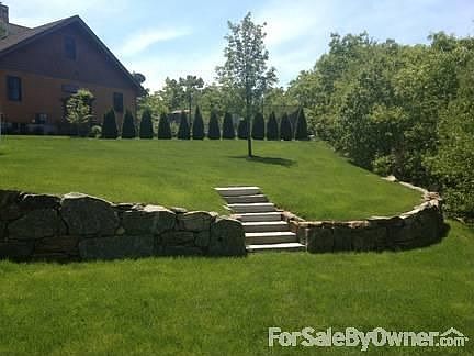 Rolling lawn with granite retaining wall