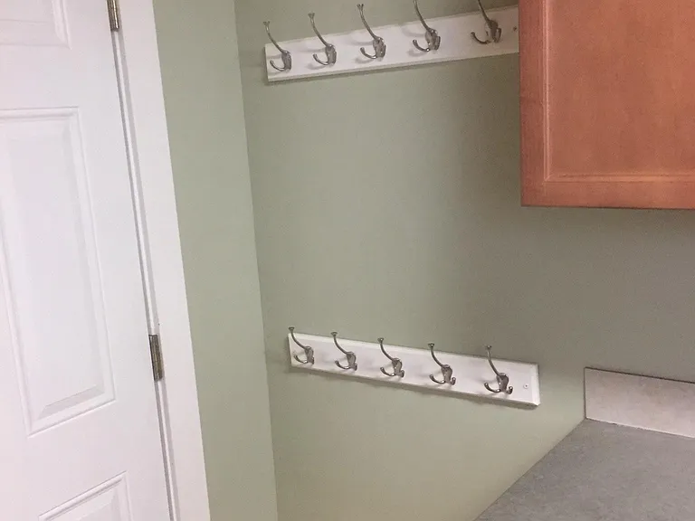 Custom hangers in kitchen behind back door