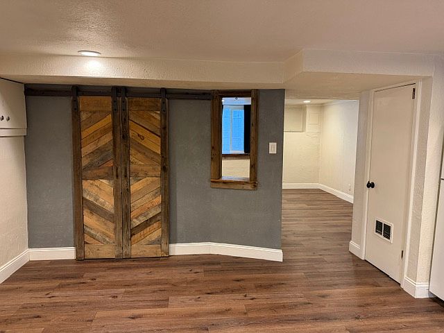 Reclaimed wood barn doors, storage closet/pantry, Pass through for style. storage, and light flow into kitchen