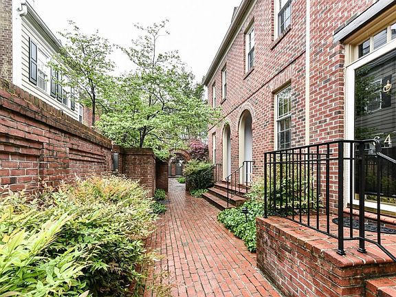 The charming brick pathway leads to the entrance that is nestled in the quiet center of the townhouse community.