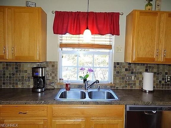 Kitchen with newer sink and backsplash.