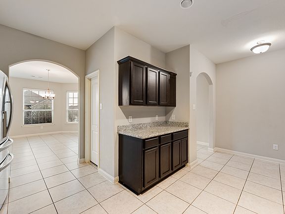 A look of the breakfast bar and pantry in this gorgeous kitchen!