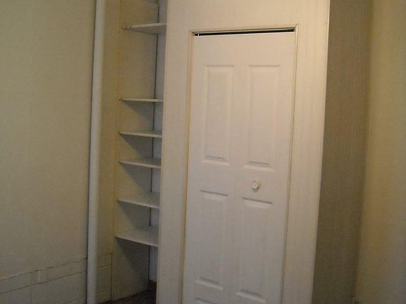 Closet in bathroom also has shelving on the side