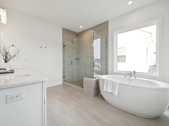 Spa-like primary bathroom with dual sinks and deep tub
