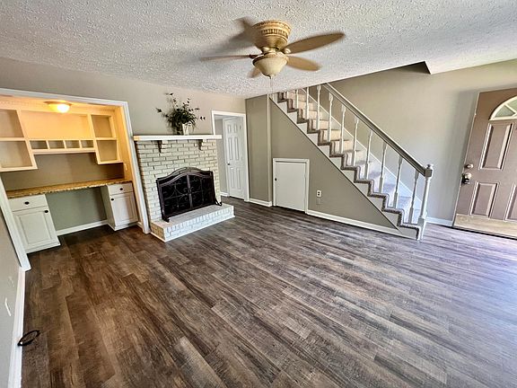 Spacious LR with additional storage under staircase.