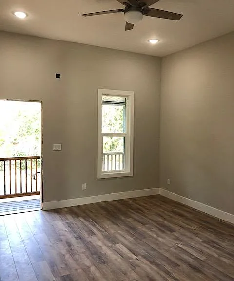 Living room looks out towards the private porch and the tree lined streets.