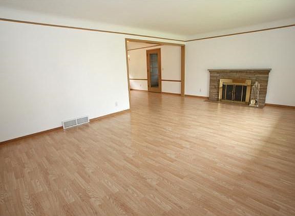 Huge bright living room with tons of natural light. Wood burning fireplace is ready to go or you can use electric one.