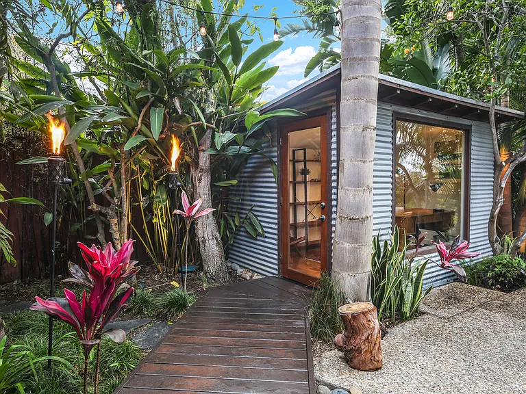 Detached office contained within the enclosed backyard. Huge picture window that looks onto the backyard