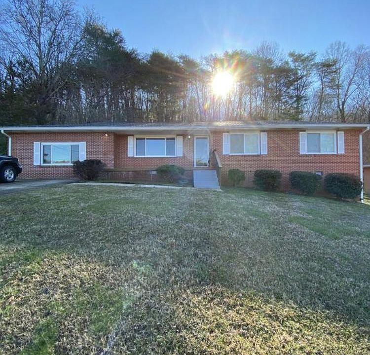Single story brick home on large 1/2 acre lot