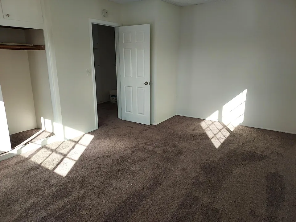 bedroom 1 with double closet and store space above closet