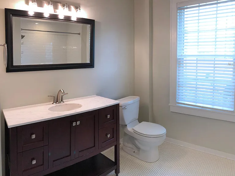 _ Master bathroom with large vanity, tiled floors and origin