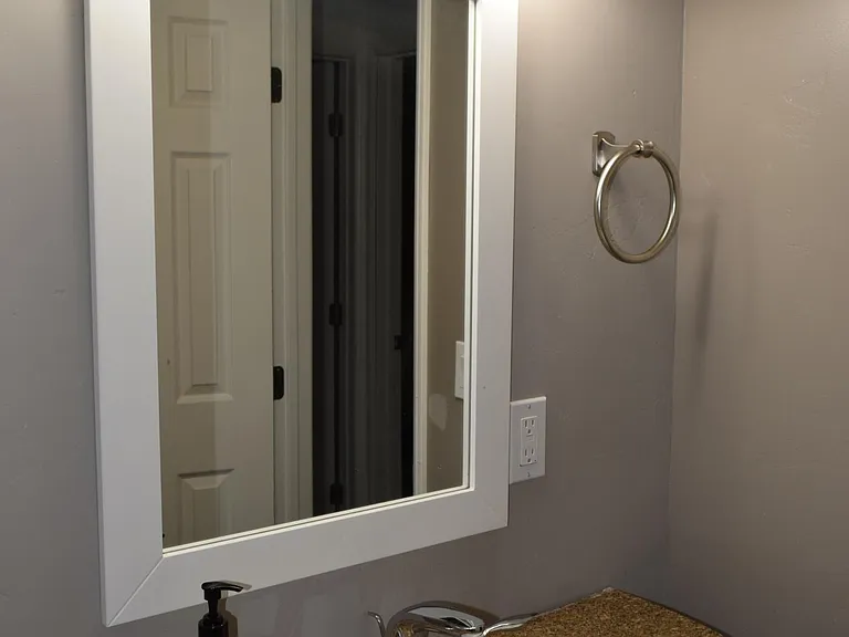 The vanity features a granite counter top and various sections for your toiletries.