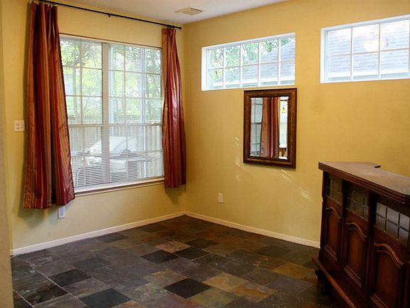 Den off of kitchen with authentic slate flooring.