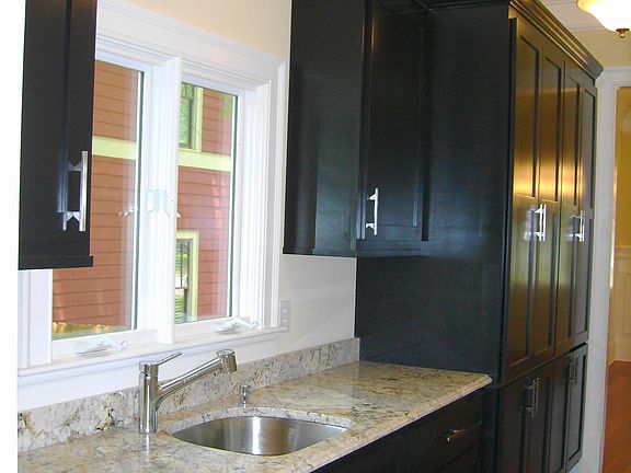 Huge Butlers Pantry with granite,sink,and tons of cabinetry.