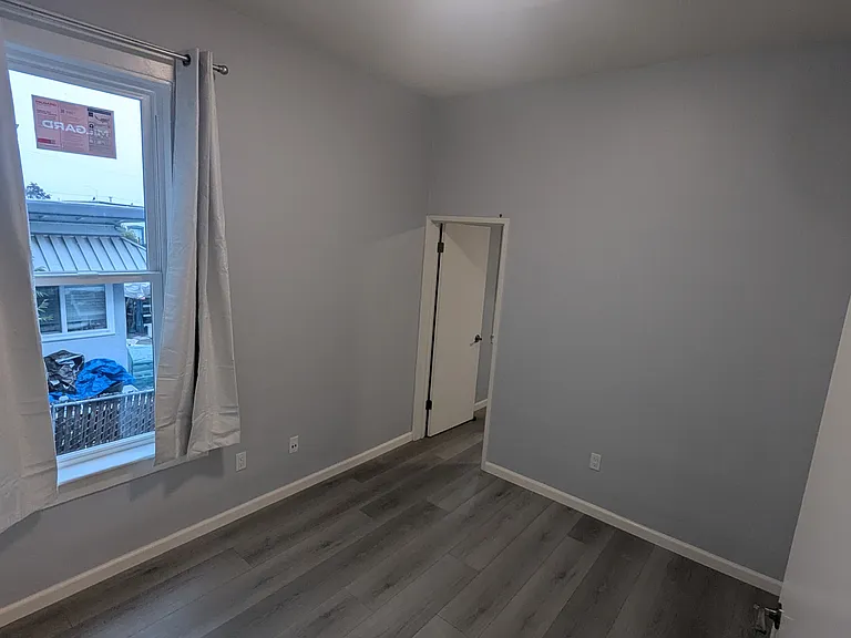 Office looking towards bedroom. New floors, new windows and curtains.