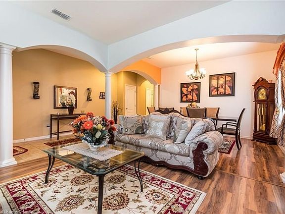 Formal living and dining room with lovely columns and laminate flooring