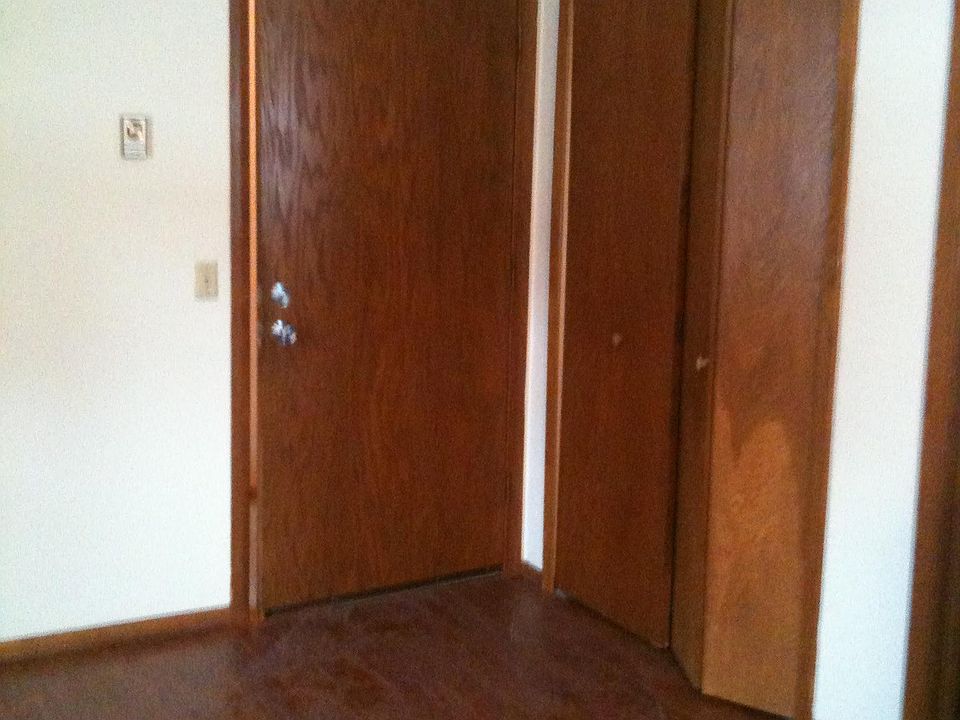 Front door to apartment and front entrance closet