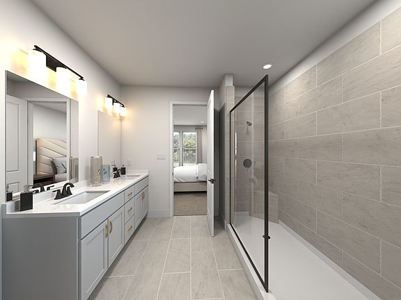 The primary bathroom offers dual vanity sinks and a walk-in shower.