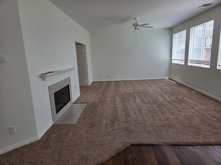 Large Family Room with Ceiling Fan and Fireplace.