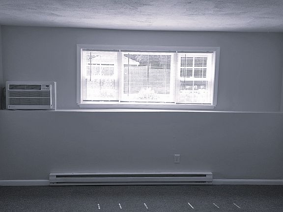 Living Room View with Picture Windows and Coat Closet