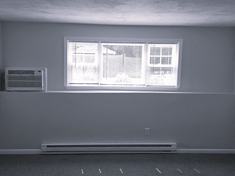 Living Room View with Picture Windows and Coat Closet
