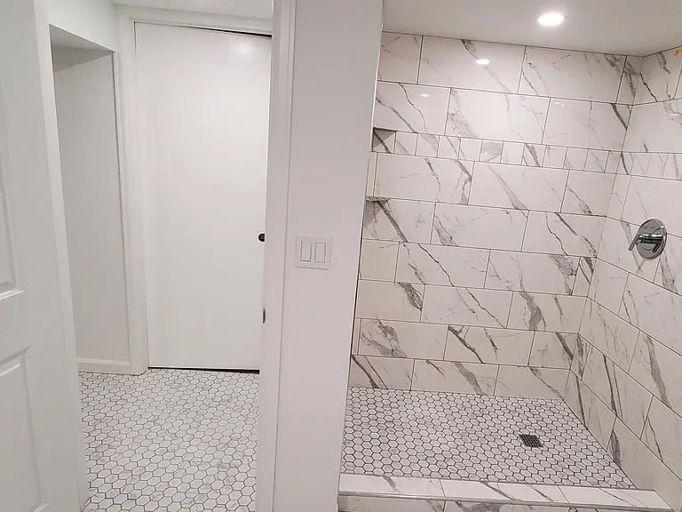 Downstairs bathroom with new shower with beautiful tile work