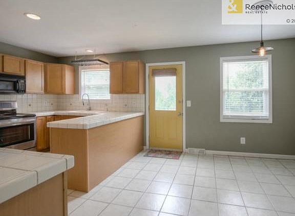 Spacious Eat-in kitchen with beautiful tile floors and counter t