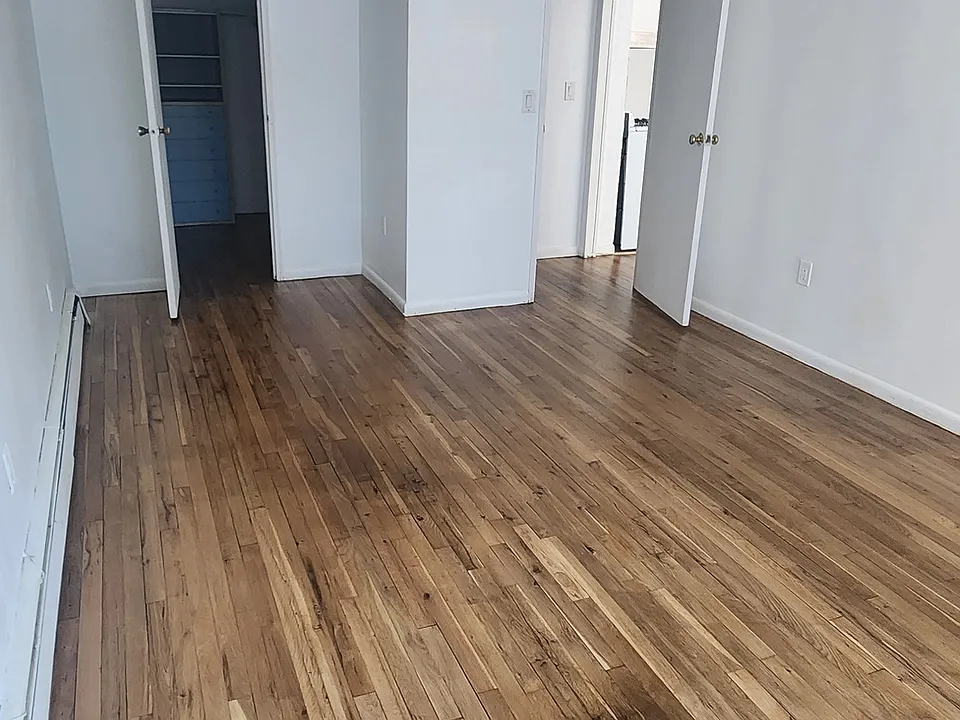 View from bedroom facing door and closet