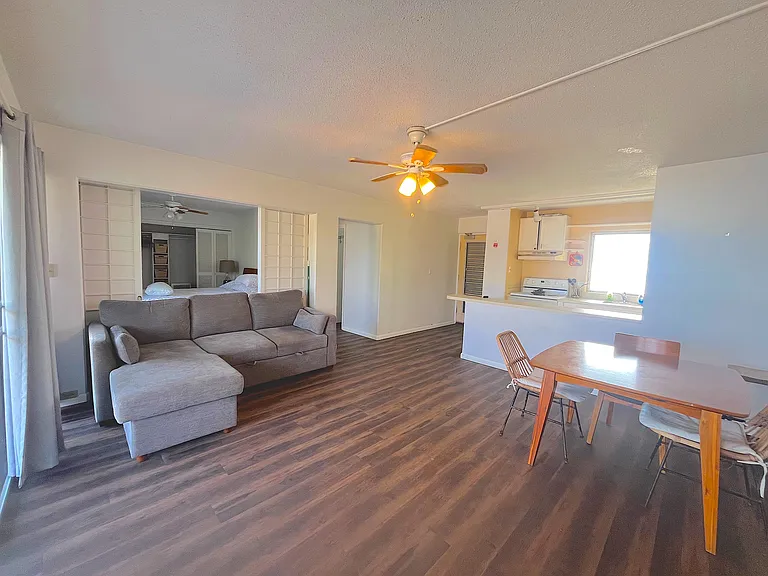 Main living space from lanai side. Doors to primary bedroom are open in this photo to show versatility.