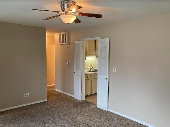 Family room going into kitchen and hallway to bath and bedrooms