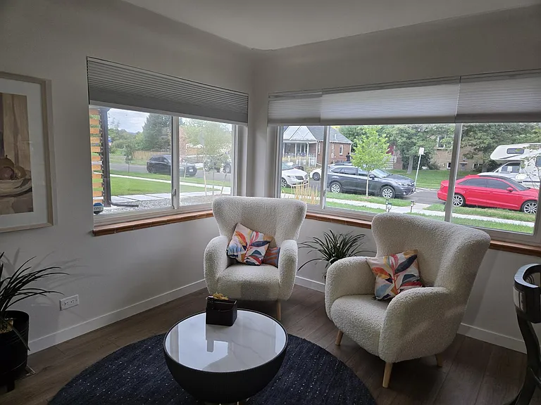 Living room/ dinning room offers year round lovely sun filled area with two corner windows that allows a view of the park.