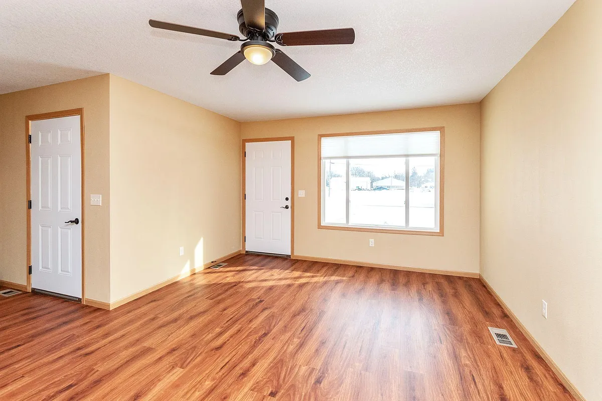 Living Room with access to front entry. Garage entrance on the left. - 200 E Main St
