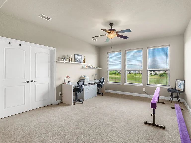 Big gameroom upsatirs includes a desk-homework center. Double doors lead to the fully enclosed media room.
