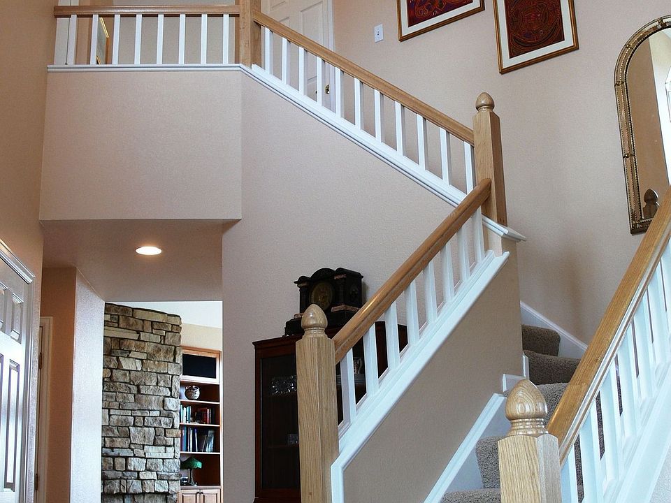 Upgraded HW floors and custom banister overlooks the family room