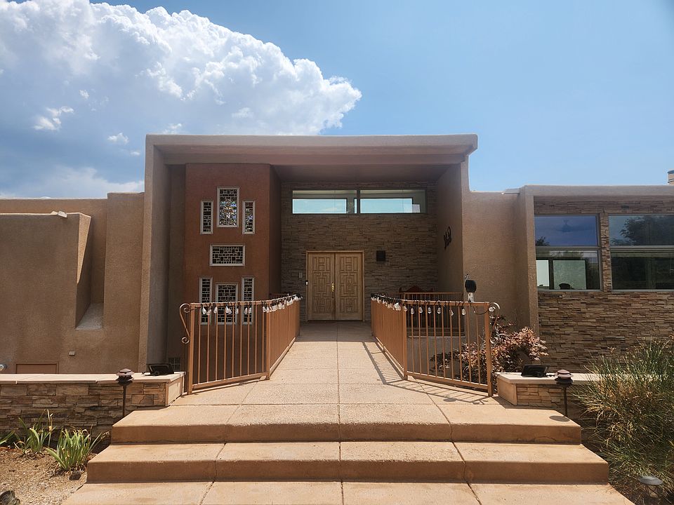 Front of home, with bridge and wall of hammered glass; enter on top floor.