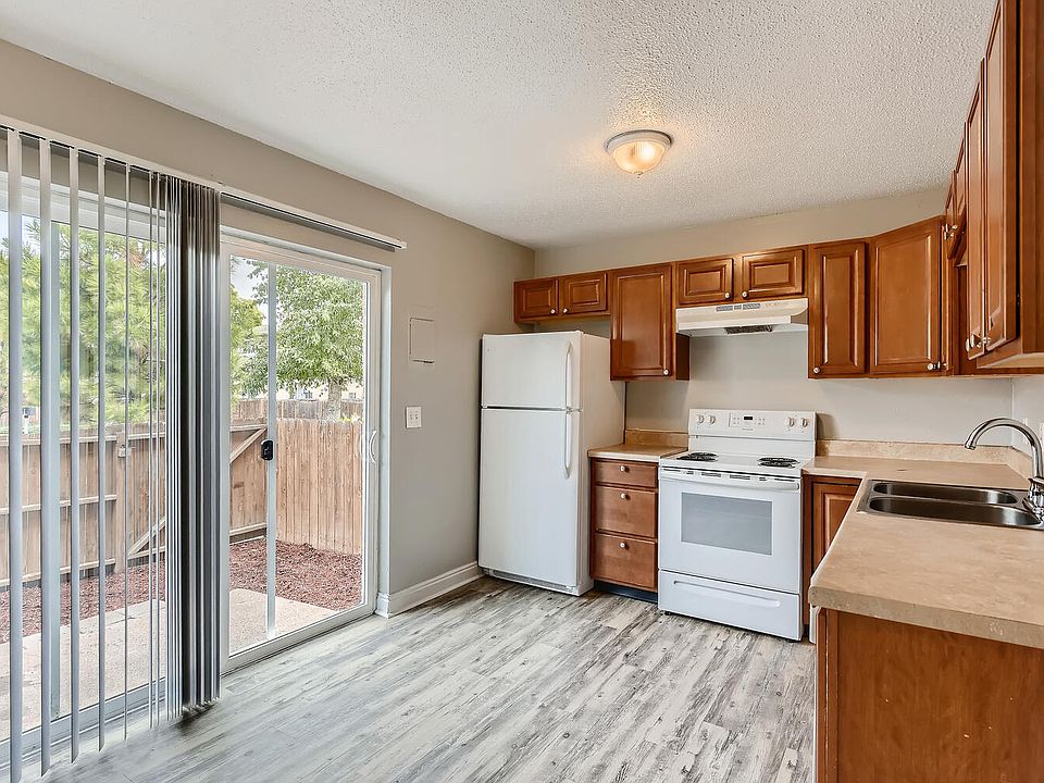 A kitchen with a Sliding Door, Refrigerator and Range oven at Alder Square Rental Townhomes