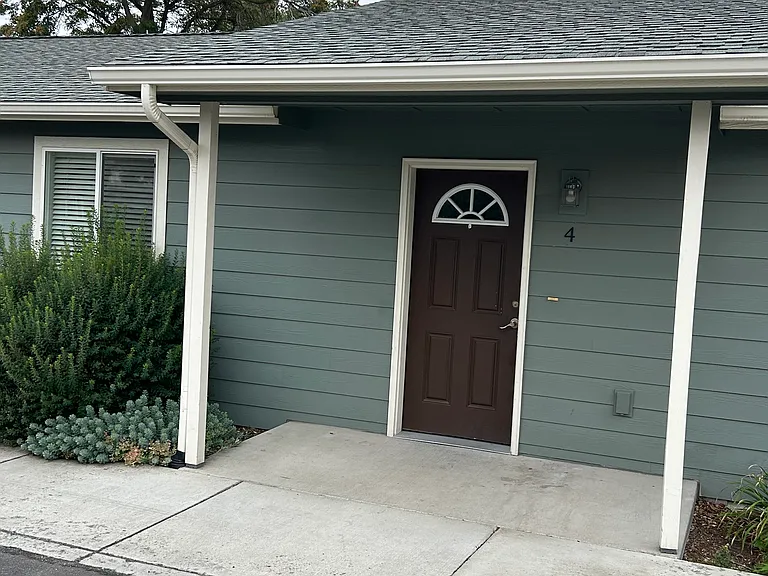 Front of unit with one of two dedicated parking space in front of unit.