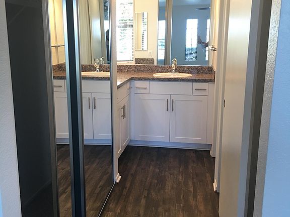 Dual closets & mirrored doors in the master bathroom. Has hi