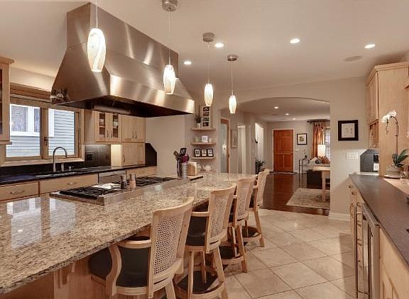 THE PERSON WHO LOVES TO ENTERTAIN WILL APPRECIATE THE DOUBLE OVEN, 48" GAS RANGE GE MONOGRAM APPLIANCES, BOSCH DW, WET BAR, BEVERAGE FRIDGE AND LOADS OF COUNTER SPACE.