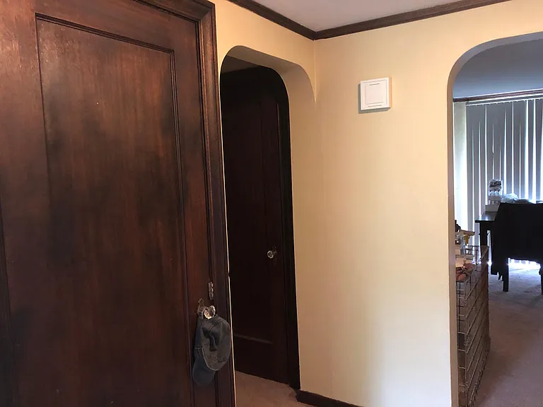 Hall closet doors; bedroom through left archway; dining to the right archway