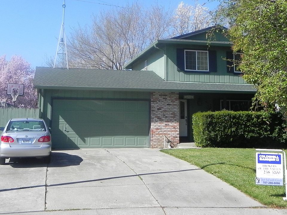 street view with RV parking and access to backyard through gate. 